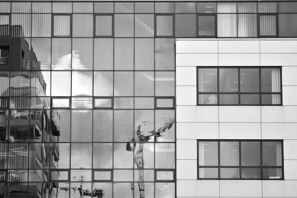 istock Modern building with reflected sky and cloud in glass window. Black and white. 1096154194