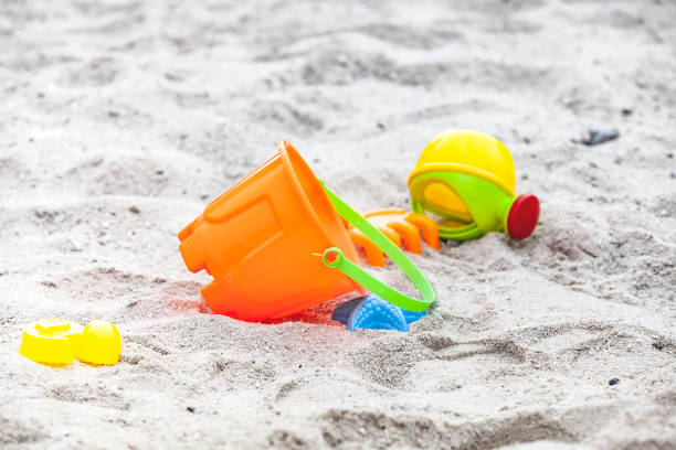 istock Set of color plastic toys on a sand 1096156480