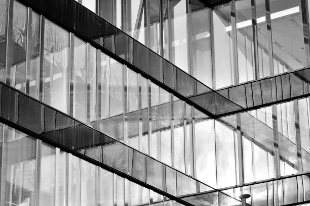 istock Modern building with reflected sky and cloud in glass window. Black and white. 1096156718
