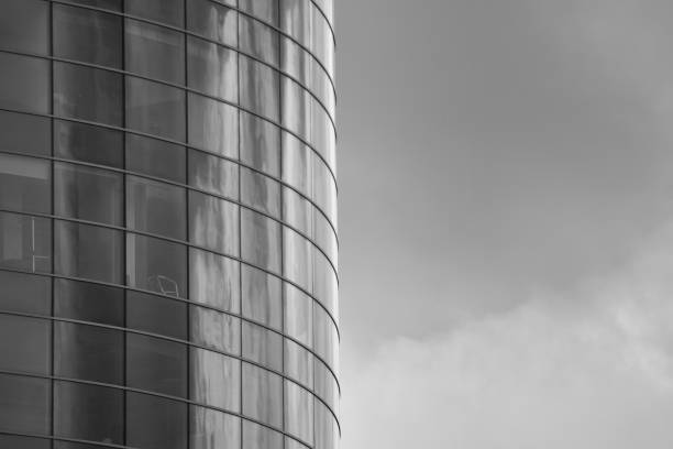 istock Modern building with reflected sky and cloud in glass window. Black and white. 1096157330