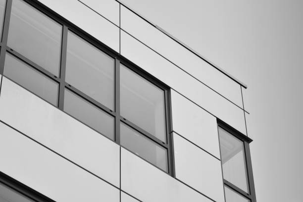 istock Modern building with reflected sky and cloud in glass window. Black and white. 1096159346