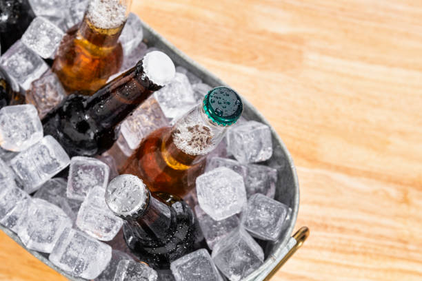 istock Looking down on assorted beer bottles on ice in galvanized tub on a wood table 1096160266