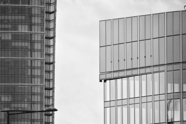 istock Modern building with reflected sky and cloud in glass window. Black and white. 1096160918