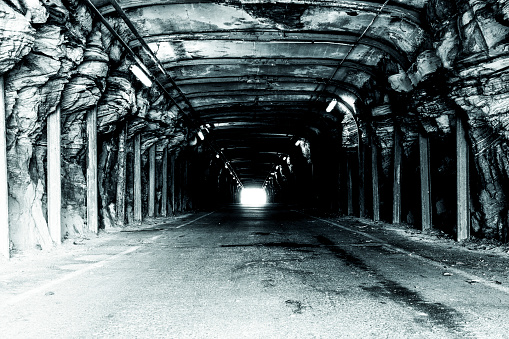 Black and white photo of old underground tunnel, background with copy space, horizontal composition