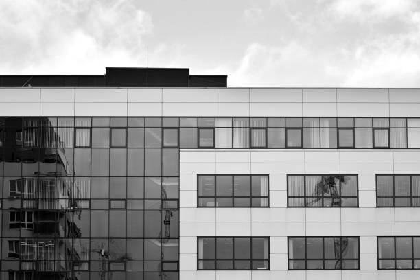 istock Modern building with reflected sky and cloud in glass window. Black and white. 1096163622