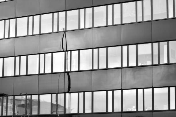 istock Modern building with reflected sky and cloud in glass window. Black and white. 1096165946