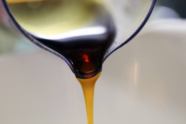 istock Pouring Syrup from a Measuring Cup to a Bowl 1096168228