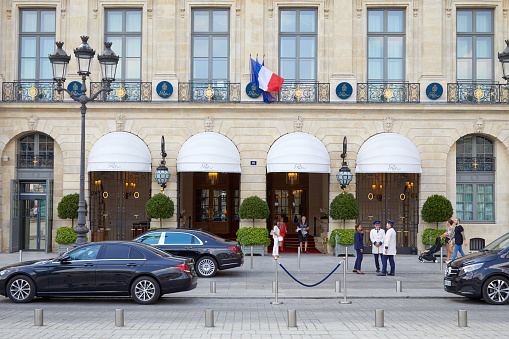 Paris, France - July 7, 2018: Ritz luxury hotel in place Vendome in Paris, people walking and black cars