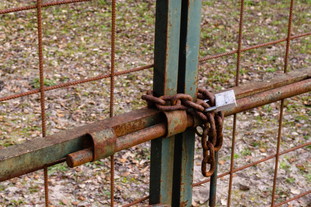 istock Old Padlock Hanging on a Rustic Chain and a Metal Gate. Retro. 1096174952