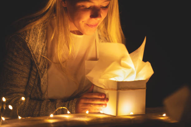 istock Woman opening a gift box with a gift inside. 1096175410