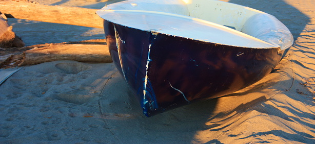 boats resting on the beach in their parking area waiting for the summer to set sail towards the blue sea