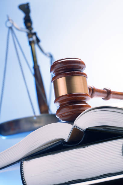 istock Gavel On Open Law Book With Justice Scale In The Background 1096194794