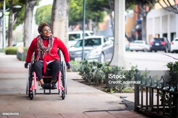 Portrait Of A Young Black Woman In A Wheelchair Stock Photo - Download Image Now - Wheelchair, Disability, People