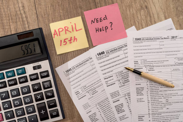 istock 1040 tax form with calculator, pen and 'need help' text 1096195274
