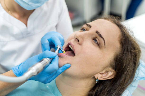 istock Dentist polishing patient's teeth after whitening procedure 1096195820