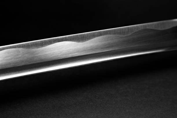 sharp blade of a japanese katana sword metal pattern of a sharp blade of a japanese katana sword ancient chinese weapons stock pictures, royalty-free photos & images