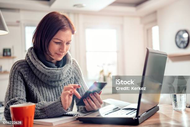 Woman Typing Text Message On A Smart Phone Stock Photo - Download Image Now - Computer, Happiness, Home Finances