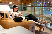 Traveling business woman relaxing in a VIP lounge at the airport
