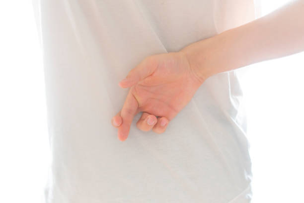 istock person crosses his fingers behind his back b 1096225426
