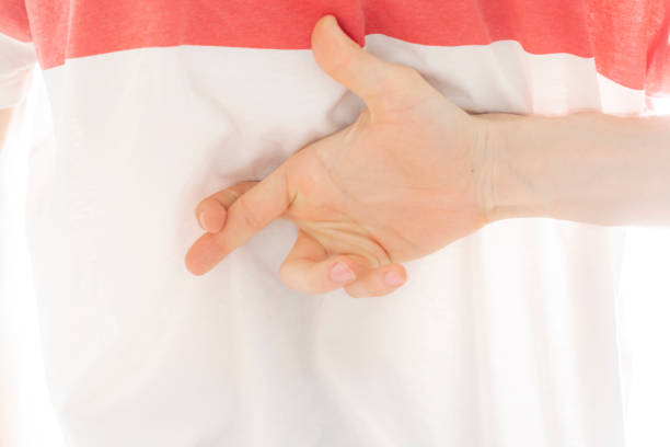 istock person crosses his fingers behind his back b 1096225454