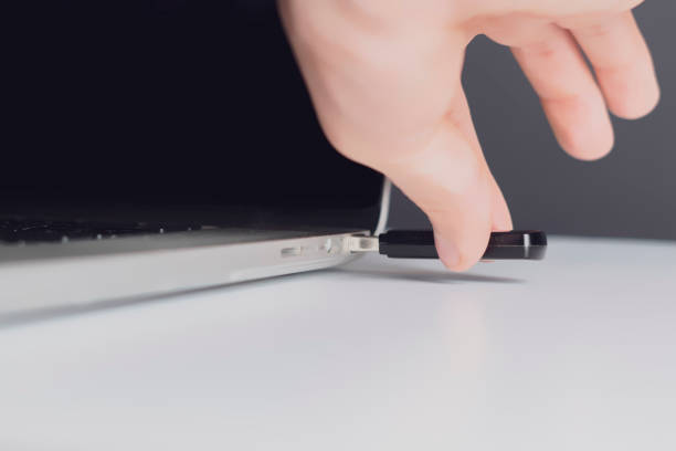 istock male hand connect usb flash drive in a laptop device b 1096225548