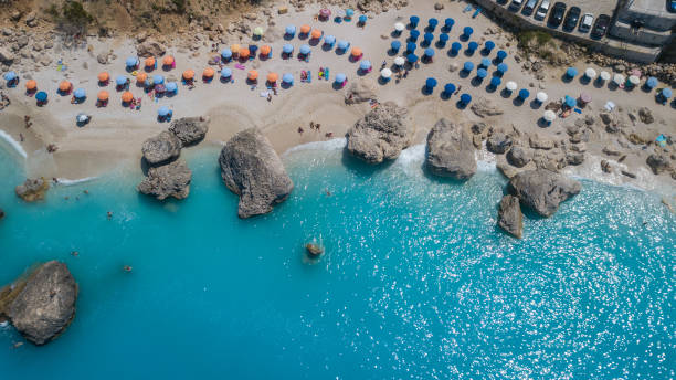 istock Beautiful beach filled with umbrellas and big rocks 1096232106
