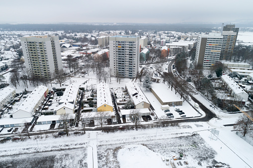 Aerial view of rows of houses and apartment buildings in winter.