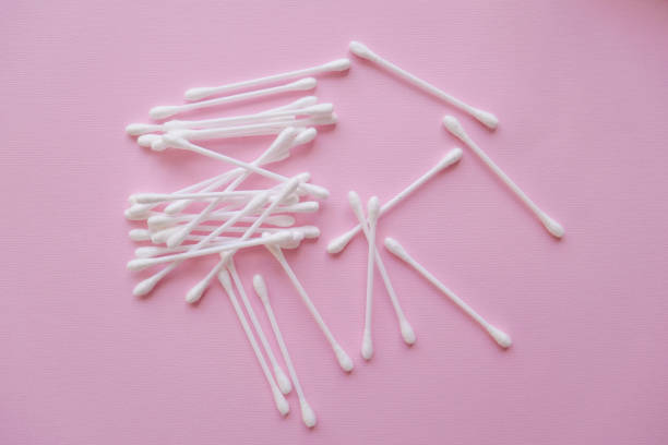 istock white plastic cotton buds on a pink background, Flat lay, view from above 1096254920