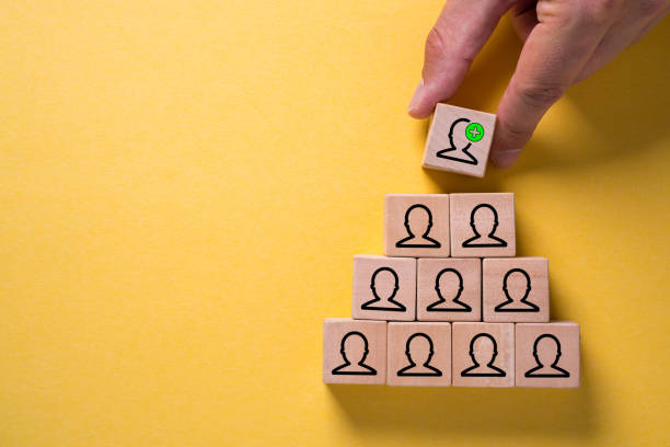 istock organization and team structure symbolized with cubes and a hand changing the top tier 1096262888