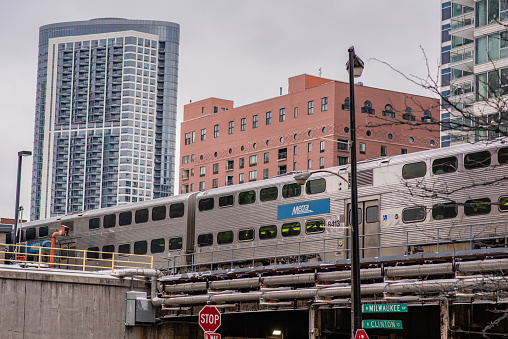 Chicago, IL / USA - January 13, 2019: The Metra train passes above on elevated tracks, downtown Chicago. Millions take public transit yearly in the city.