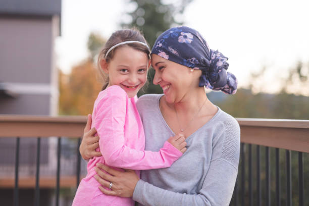 istock Mother with cancer hugging her daughter outside 1096280072