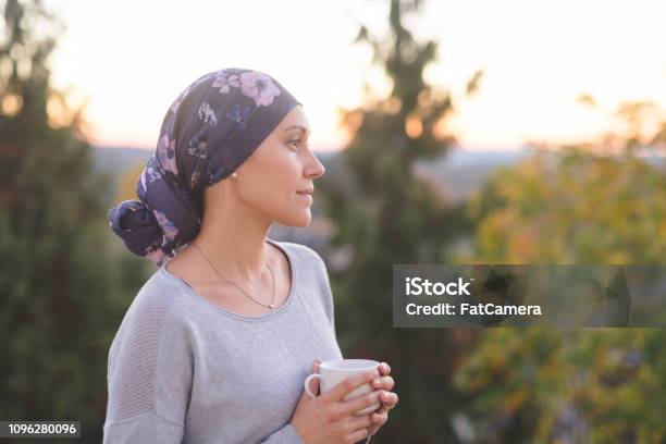 Woman Battling Cancer Stands Outside And Contemplates Her Life Stock Photo - Download Image Now