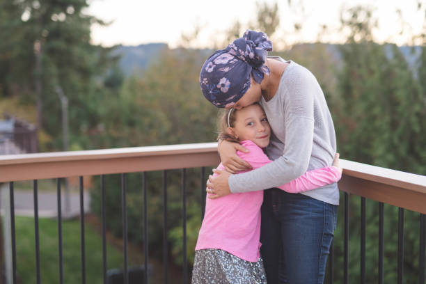 istock Mother with cancer hugging her daughter 1096280104