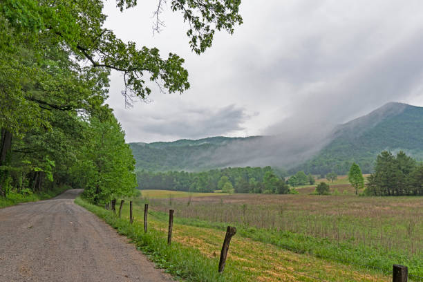 istock Fog lays over the fields and road in Cades Cove. 1096282698