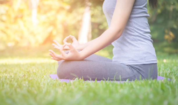 istock fitness girl practicing yoga in park 1096296324