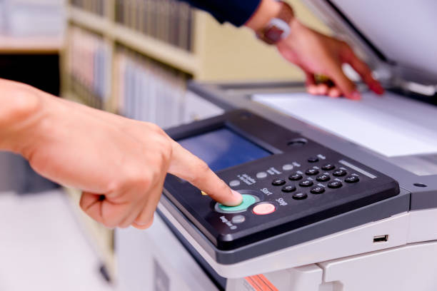 istock Bussiness man Hand press button on panel of printer, printer scanner laser office copy machine supplies start concept. 1096298980
