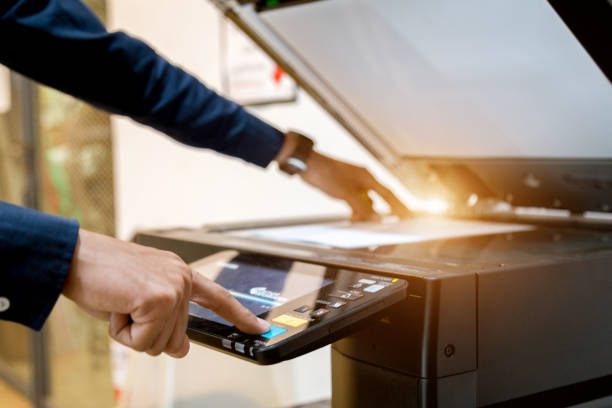 istock Bussiness man Hand press button on panel of printer, printer scanner laser office copy machine supplies start concept. 1096299200