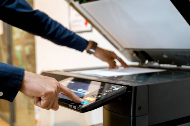 istock Bussiness man Hand press button on panel of printer, printer scanner laser office copy machine supplies start concept. 1096299280