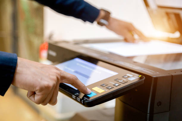 istock Bussiness man Hand press button on panel of printer, printer scanner laser office copy machine supplies start concept. 1096299326