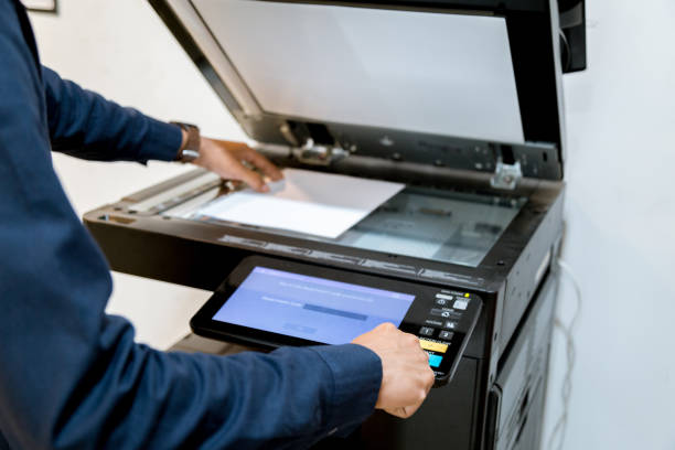 istock Bussiness man Hand press button on panel of printer, printer scanner laser office copy machine supplies start concept. 1096299578