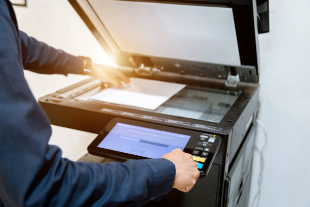 istock Bussiness man Hand press button on panel of printer, printer scanner laser office copy machine supplies start concept. 1096299632