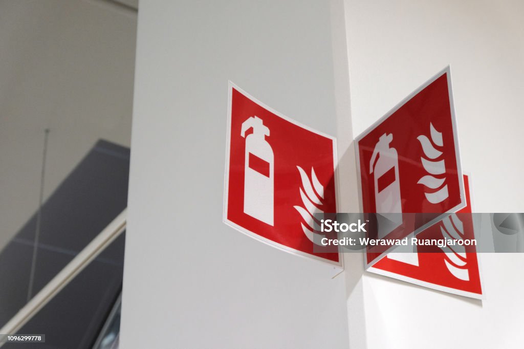 Fire extinguisher sign on the white wall. Fire extinguisher sign on the white wall Protection Stock Photo