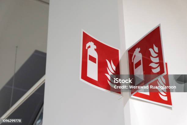 Fire Extinguisher Sign On The White Wall Stock Photo - Download Image Now - Protection, Sign, Safety