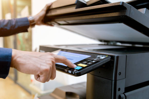 istock Close-up bussiness man Hand press button on panel of printer, printer scanner laser office copy machine supplies start concept. 1096299808