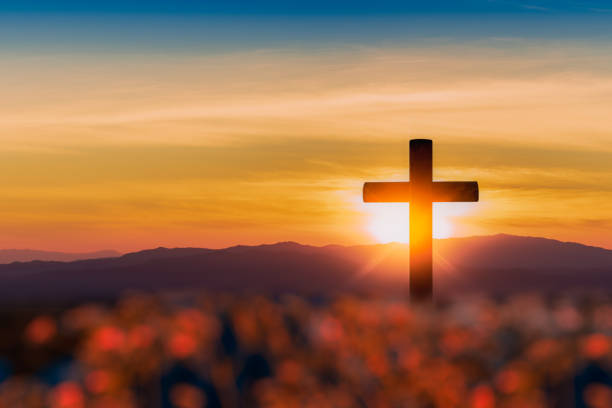 istock Silhouette of cross on mountain sunset background. 1096303226