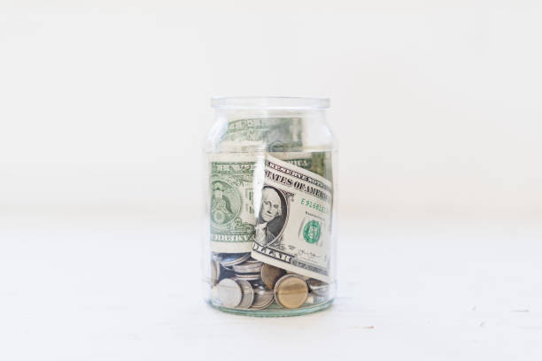 istock Saving money Money in a glass bottle White background 1096308720