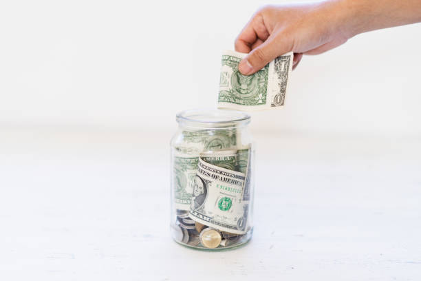 istock Saving money Money in a glass bottle White background 1096308722