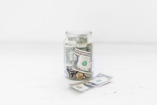 istock Saving money Money in a glass bottle White background 1096308732