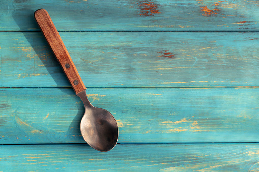 rustic spoon on wooden table