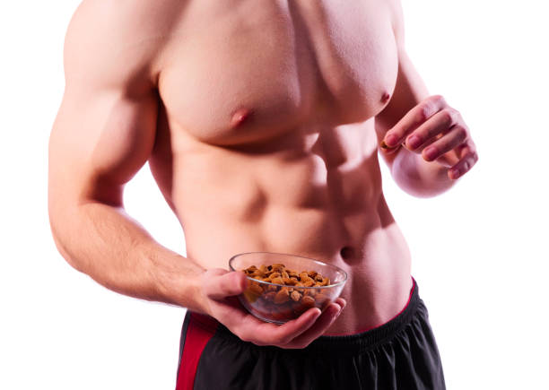 istock Sporty muscular man with almond nuts 1096323432